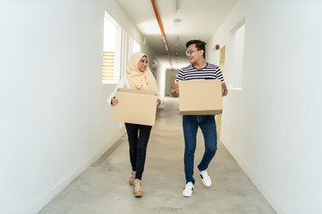 Fototapeta na wymiar asian couple moving house together with box