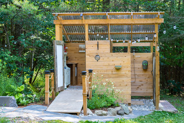 Fototapeta na wymiar Outdoor shower and composting toilet stall at a glamping site