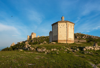 Rocca Calascio (Italy) - The ruins of an old medieval village with castle and church, over 1400 meters above sea level on the Apennine mountains in the heart of Abruzzo, at sunset.