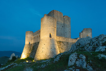 Fototapeta na wymiar Rocca Calascio (Italy) - The ruins of an old medieval village with castle and church, over 1400 meters above sea level on the Apennine mountains in the heart of Abruzzo, at sunset.