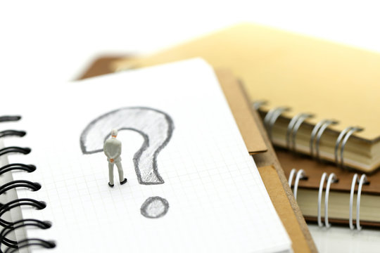 Miniature people : Businessman with THE QUESTION MARK using for concept Punctuation Day