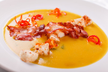 Traditional Spanish cold soup, with bread sticks and bacon chips. Corn Spanishwith bacon. chowder