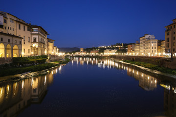 Fototapeta na wymiar Florence, Italy, Arno river, view from Ponte Vecchio at Ponte alle Grazie, dark blue sky, yelow lamps, Lungarno Acciaiuoli