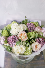 Floral Arrangement. Mix flowers. Beautiful summer bouquet in vase. Concept of a flower shop. Profession florist