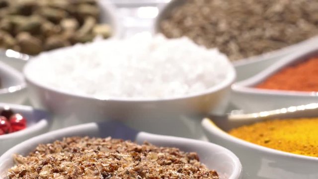 Dry spices on a rotary table. 4K. Macroshooting.