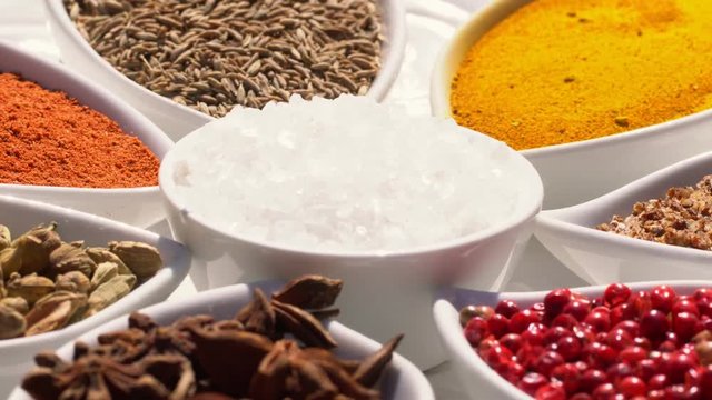 Dry spices on a rotary table. 4K. Macroshooting.