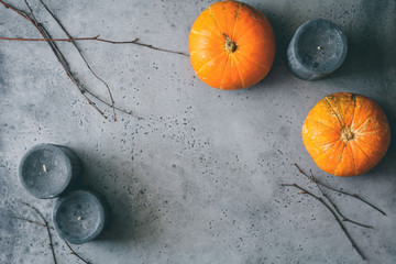 Halloween background, still life flat lay composition of black candles, small pumpkins, dried...