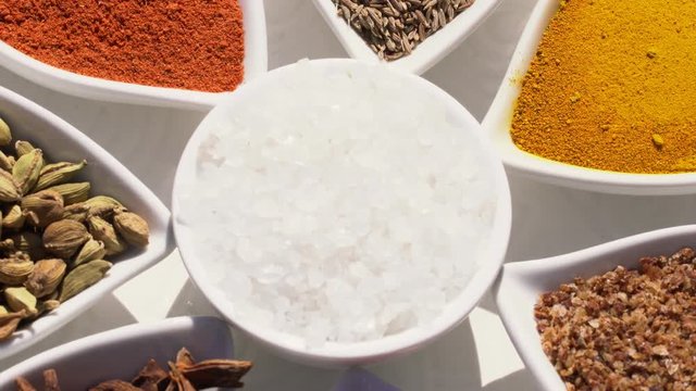 Dry spices on a rotary table. 4K. Macroshooting.