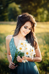 Naklejka na ściany i meble Young beautiful woman girl hold bouquet of flowers camomile and smile. Concept of happiness and harmony