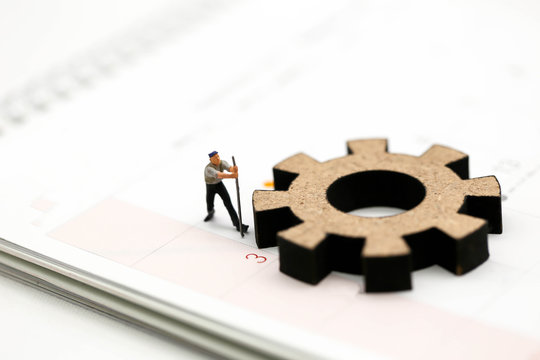 Miniature people : Worker and tool with Calendar Using for concept Calendar Adjustment Day.