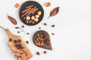 Autumn food background. Nuts, cinnamon sticks, anise stars, berries, dried flowers and leaves. Autumn, fall concept. Flat lay, top view