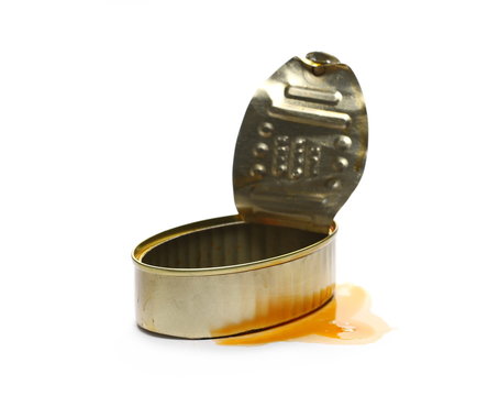 Opened empty fish tin can with spilled sauce, isolated on white background