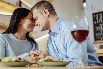 Happy time. Wonderful joyful couple enjoying the evening while having dinner