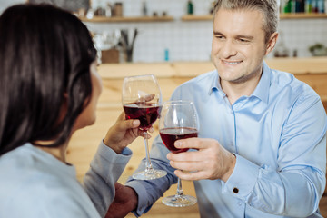 Happy time. Good-looking man having a date with a lady while drinking good wine