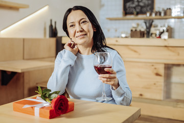 Sweet dreams. Shy woman thinking while drinking wine
