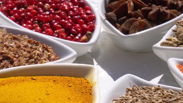 Dry spices on a rotary table. 4K. Macroshooting.