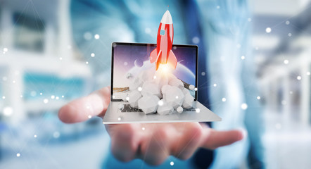 Businessman with rocket launching from a laptop 3D rendering