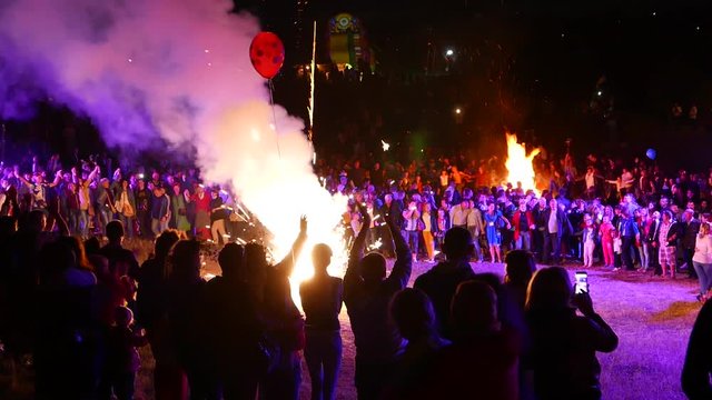 Celebration, festival. Ethnic national feast, gala. Lot of people around the great fire, magic firework. Fest with show at the holiday