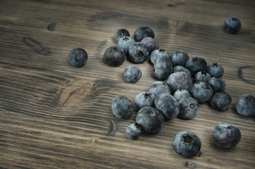 Blueberries on an grey aged wooden surface