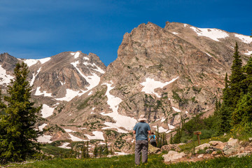 Man standing against a view of mountains