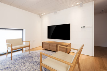television with wood chair in a white interior