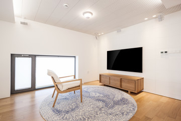 television with wood chair in a white interior