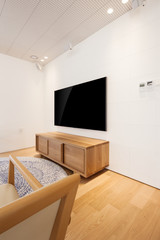 television with chair in a white interior