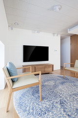television with chair in a white interior