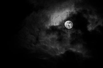 Full moon in the middle of clouds