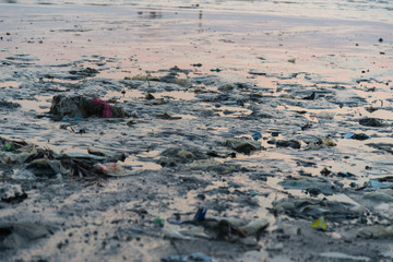 Beach pollution. Plastic bottles and other trash on sea beach