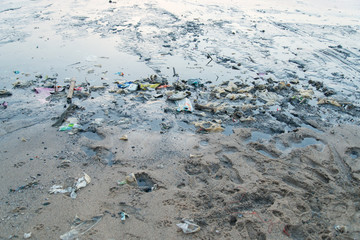 Beach pollution. Plastic bottles and other trash on sea beach