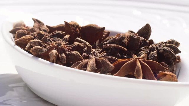 Dry spices anisetree on a rotary table. 4K. Macroshooting.