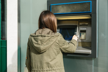 The tourist withdraws money from the ATM for further travel. Finance, credit card, withdrawal of...