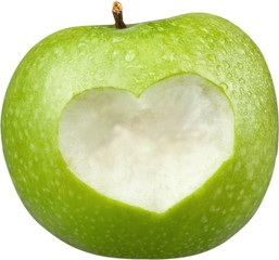 Apple with carved heart sign isolated on white background