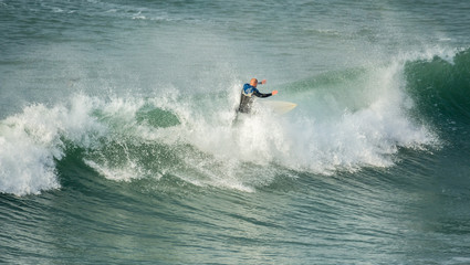 Surfer riding crest of wave, Fistral, Newquay, Cornwall