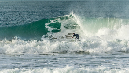 Obraz premium Surfer closing in on barrel, Fistral, Newquay, Cornwall