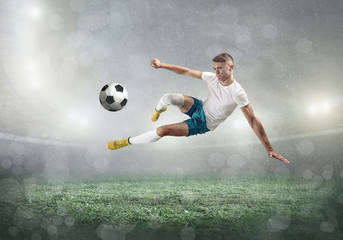 Soccer player on a football field in dynamic action at summer 