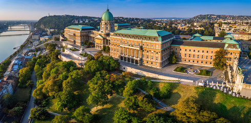 Budapest, Hungary - Aerial panoramic view of the beautiful Buda Castle Royal Palace at sunrise with Gellert Hill and Statue of Liberty at background - obrazy, fototapety, plakaty