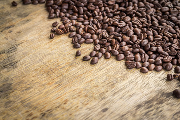 Coffee beans on old wood background