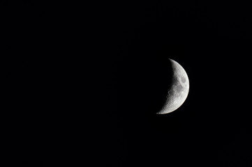 waxing crescent moon in a black night sky