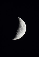 waxing crescent moon in a black night sky