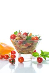 A warm salad of baked eggplant and peppers with cherry tomatoes
