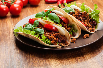 Mexican tacos with minced meat, beans and spices