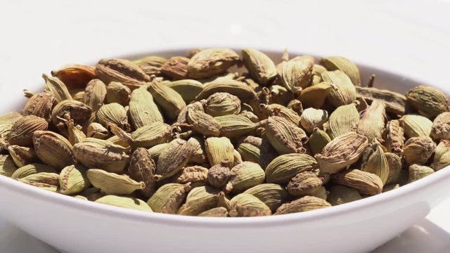 Dry spices cardamom on a rotary table. 4K. Macroshooting.
