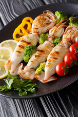 Salad of fried squid with fresh vegetables close-up. vertical