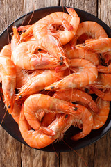 boiled large shrimp close-up on a plate. vertical top view
