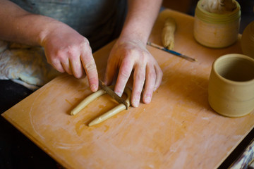 Professional male potter working in workshop, studio. Handmade, small business, crafting work...