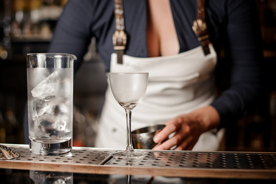 Sexy barman woman making a fresh summer cocktail