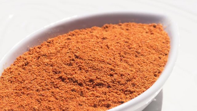 Dry spices paprika on a rotary table. 4K. Macroshooting.