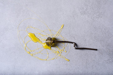 Honey background. Fresh honey  with a dipper. Grey background.